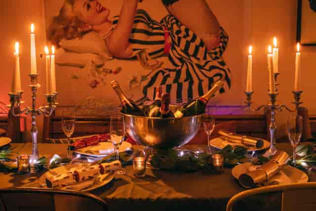 Elegant Christmas table setting with champagne centerpiece for upscale events.