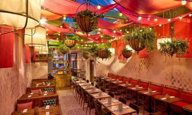 Vibrant event space at Cool Carrot with colorful drapery, perfect for gatherings.