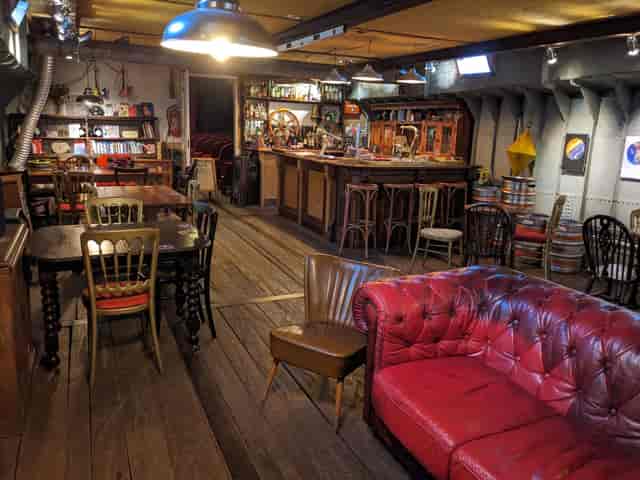 Cozy rustic event space with warm lighting for intimate gatherings and networking events.