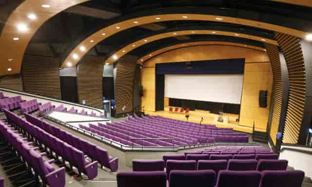 Weston Auditorium at University of Hertfordshire with tiered purple seating for events.