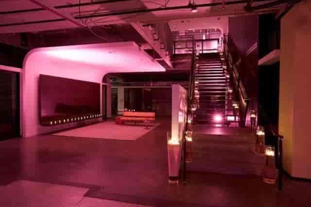 Stylish event space with illuminated staircase, perfect for upscale gatherings and celebrations.