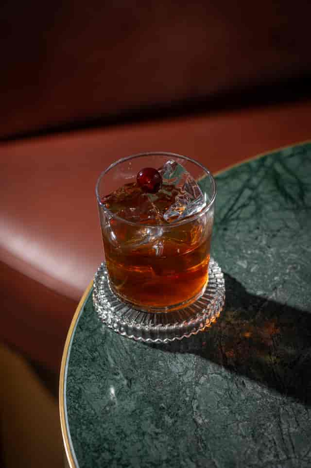Elegant cocktail with cherry garnish at The Bar, Clays Birmingham for networking events.