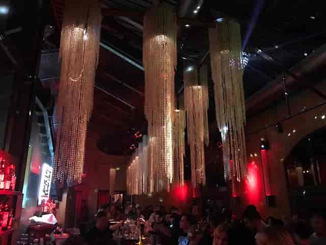 Stylish event space at Club Soda 23 with elegant chandeliers for upscale gatherings.