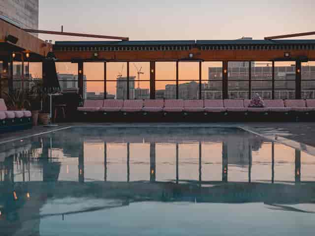 Stylish Shoreditch House rooftop venue with serene pool for upscale events.