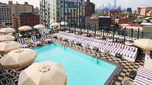 Rooftop pool at Shoreditch House with city skyline, ideal for upscale events and networking.
