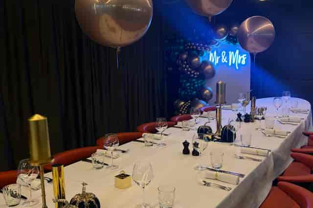 Elegant private dining space with gold accents, perfect for weddings and celebrations.