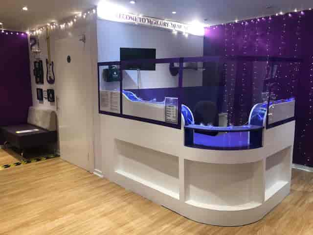 Modern recording studio reception with purple accents, ideal for creative meetings and events.