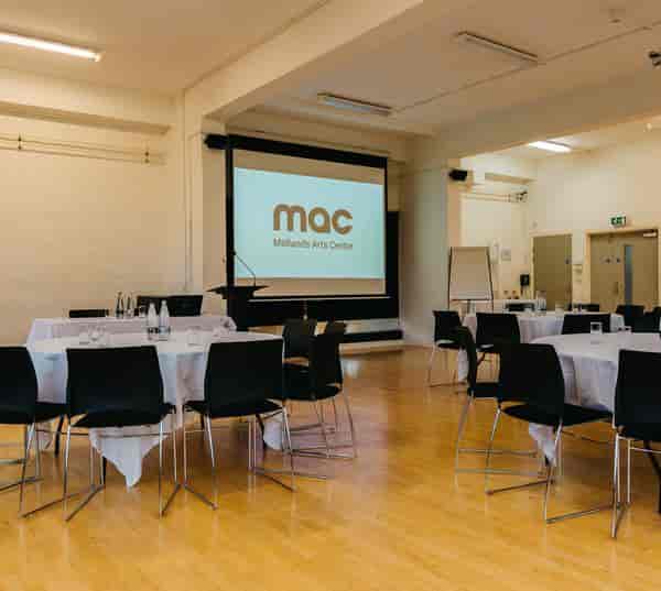 Meeting room at Midlands Arts Centre with round tables, perfect for workshops and events.