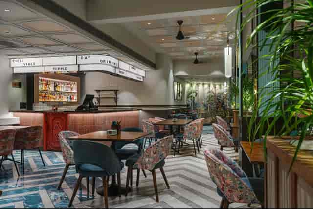 Modern event venue with elegant seating and inviting bar area for meetings.