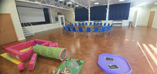 Versatile B12 Urban Village Hall with blue chairs for meetings and family-friendly events.