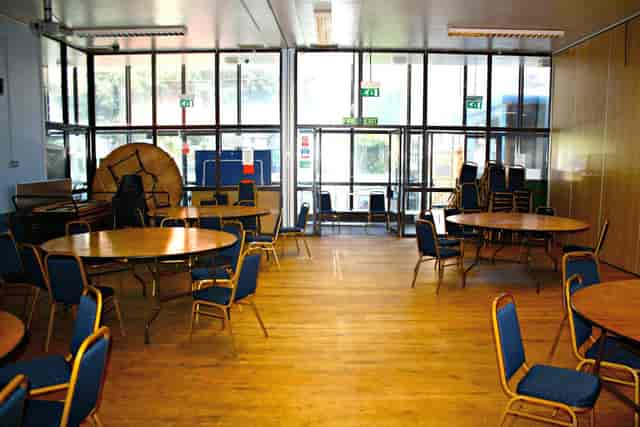 Main Hall in Kentish Town Community Centre with round tables for meetings and events.