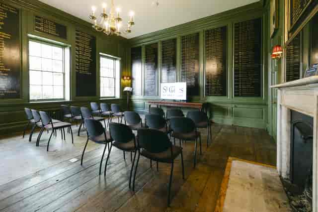 Vestry House meeting room with dark green walls, ideal for seminars and workshops.