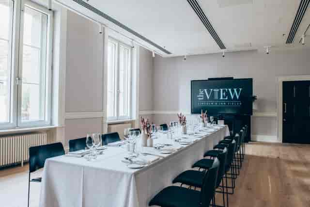 Elegant meeting space with long table, perfect for corporate events and gatherings.
