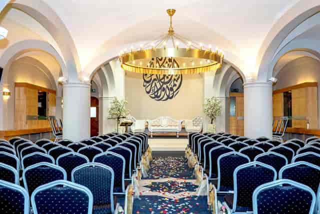 Elegant conference space with chandelier, perfect for meetings and weddings.