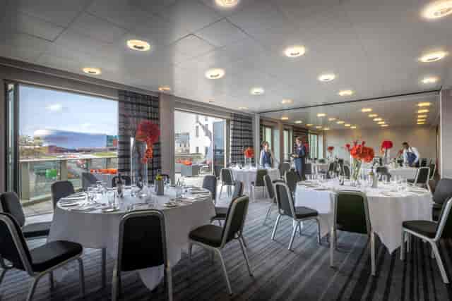 Elegant event space with round tables, ideal for corporate meetings and banquets.