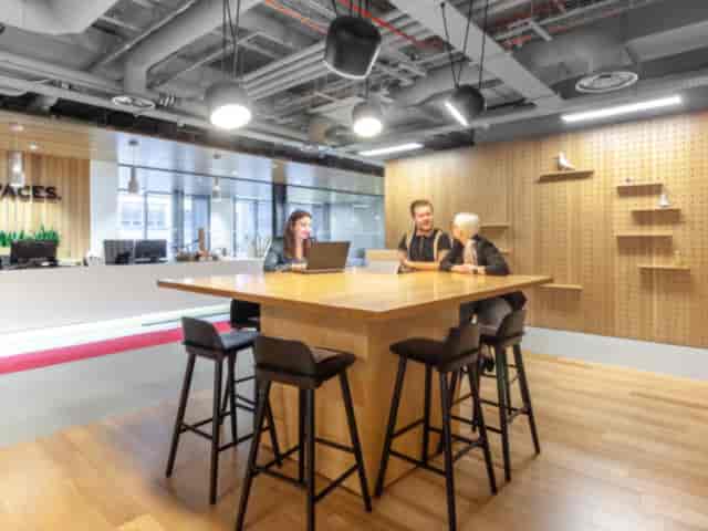 Modern meeting room in Lewis Building, Birmingham with large wooden table for events.