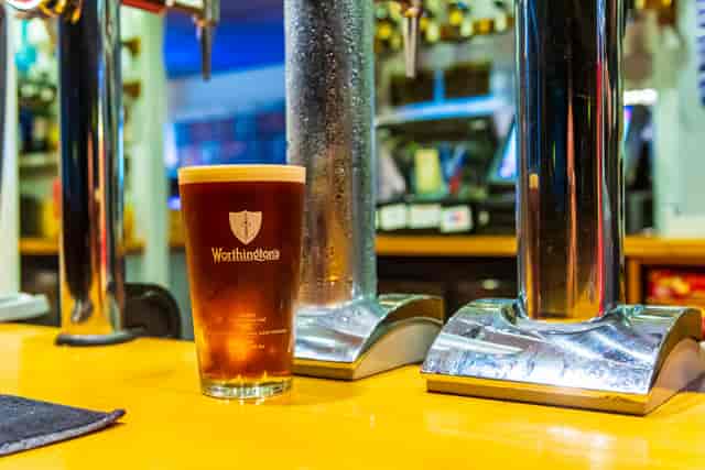 Pint of beer on polished bar at The Hasbury Club, perfect for networking events.