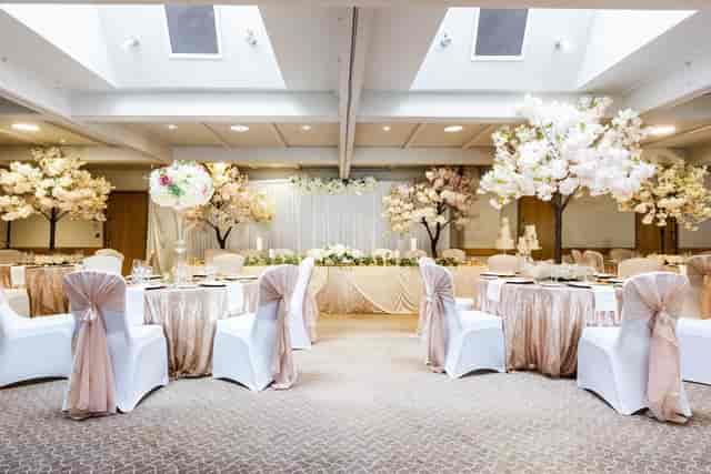Elegant wedding venue at Lea Marston Hotel with floral decor and natural light.