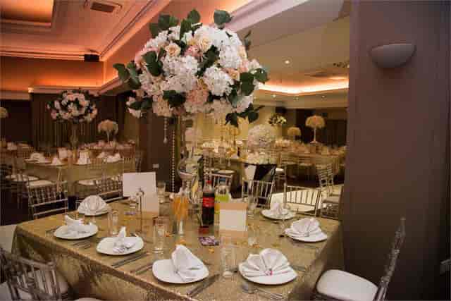 Elegant banquet hall with floral centerpieces, perfect for weddings and corporate events.