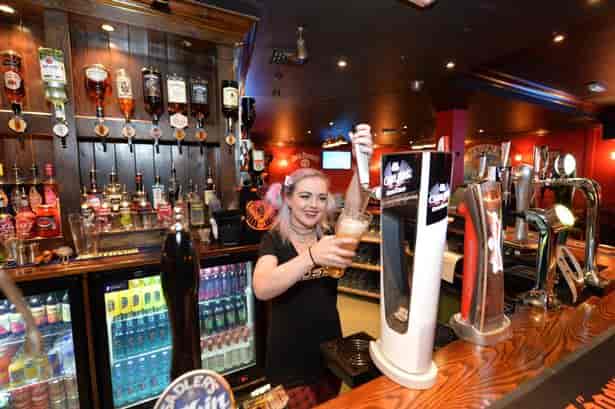 Vibrant Subside Bar scene with bartender pouring drinks for networking events.