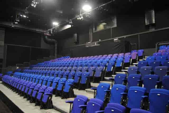 The Crossing Digbeth theater-style seating with vibrant blue and purple chairs for events.