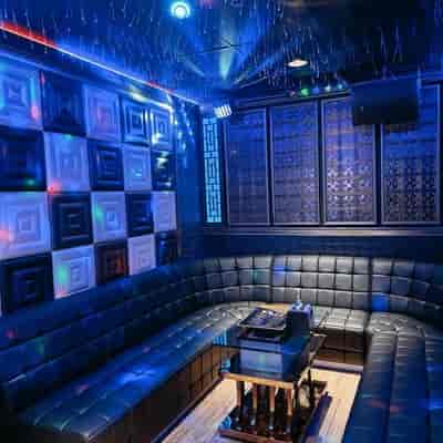 Modern KTV room with plush seating at Phoenix Live Music Bar for team-building events.
