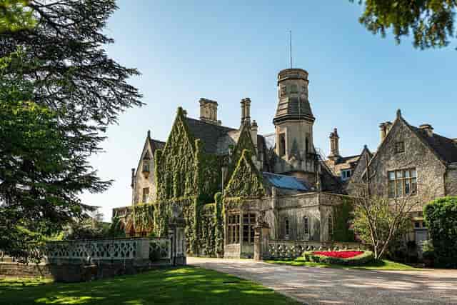 Historic Manor Arches mansion, lush greenery, ideal for upscale events and meetings.