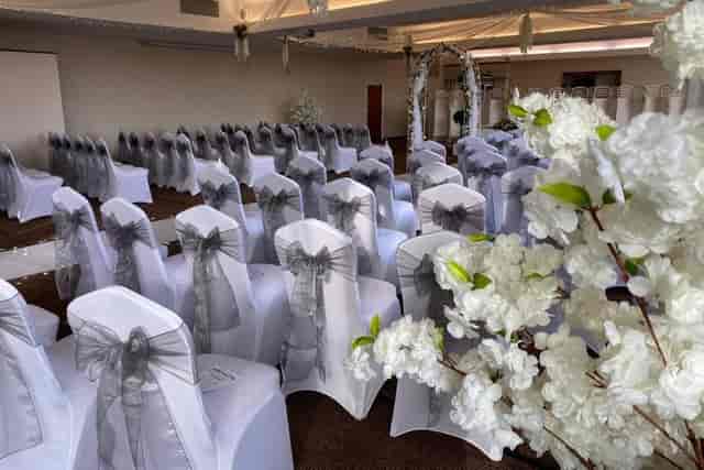Elegant dining room at Weatheroak Hall with gray-sashed chairs for weddings and events.