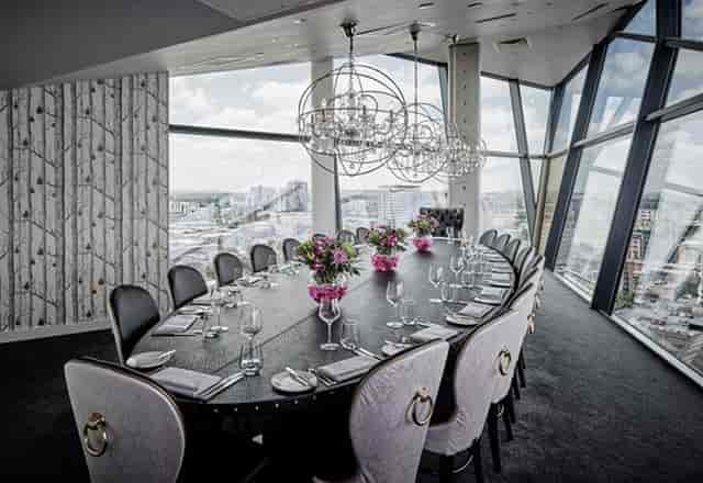Private dining room with elegant oval table for corporate meetings and exclusive dinners.
