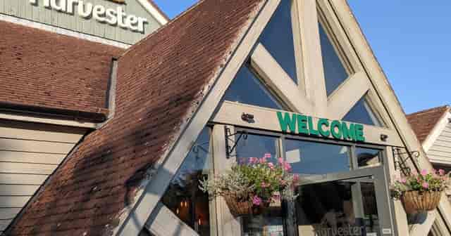 Welcoming pub entrance with charming architecture, ideal for casual meetings and events.