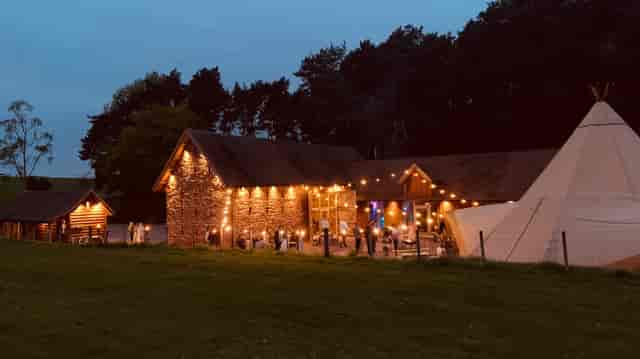 Outdoor ceremony spot at Bridal Barn with string lights, perfect for weddings and events.