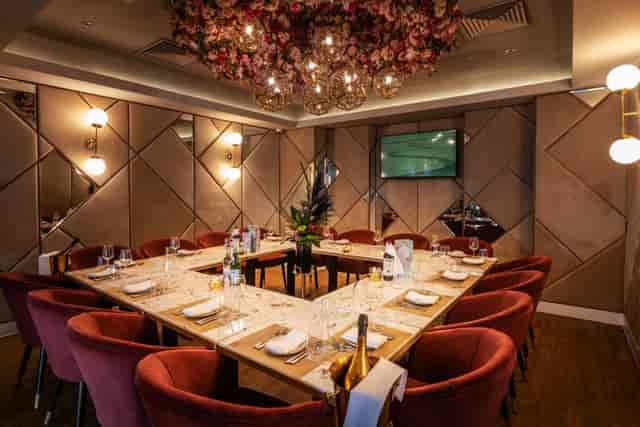 Private dining room at Adam's Restaurant with plush red chairs, ideal for corporate events.
