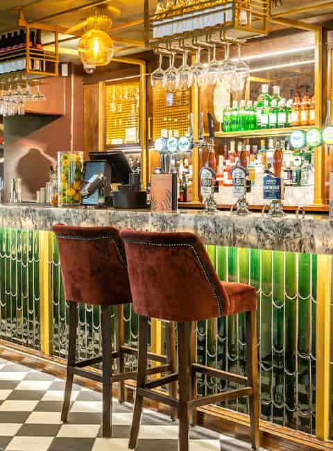 Stylish bar with marble countertop, perfect for networking events and cocktail receptions.