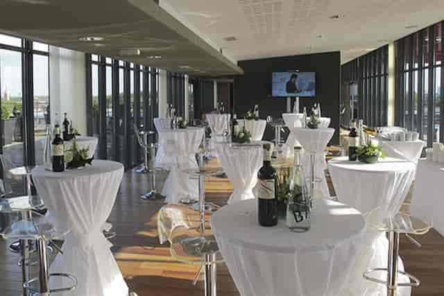 Modern VIP meeting room with high-top tables for networking events and receptions.