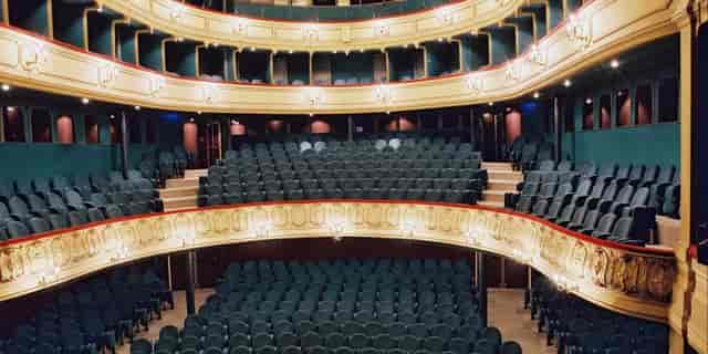 Elegant Théâtre du Gymnase with tiered seating for performances and conferences.