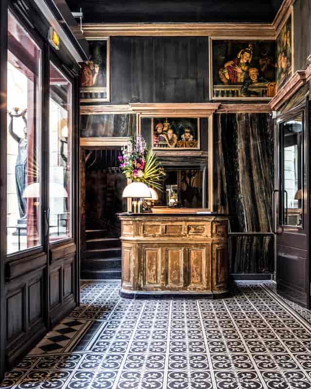 Atrium at Les Bains Paris: elegant dark decor for upscale events and gatherings.
