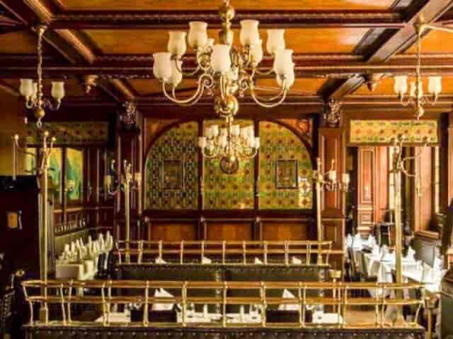 Elegant dining space with wooden paneling for upscale events at Brasserie Floderer.