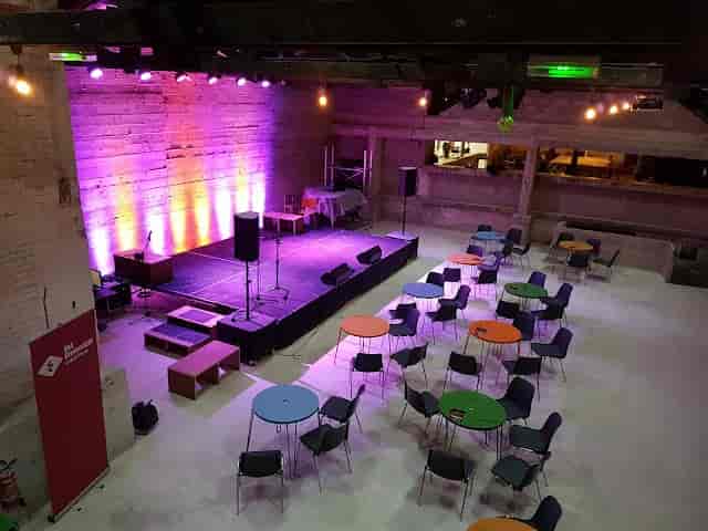 LA GRANDE SALLE event space with vibrant stage lighting for presentations and performances.