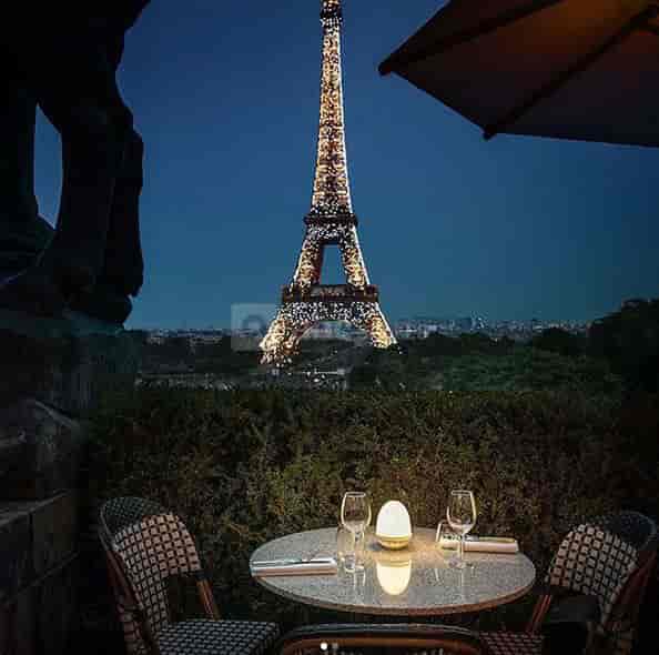Outdoor dining at Café de l'Homme with Eiffel Tower view, perfect for romantic dinners.