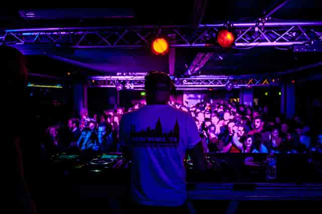 DJ performing at Le Club, La Bellevilloise, vibrant live event atmosphere.