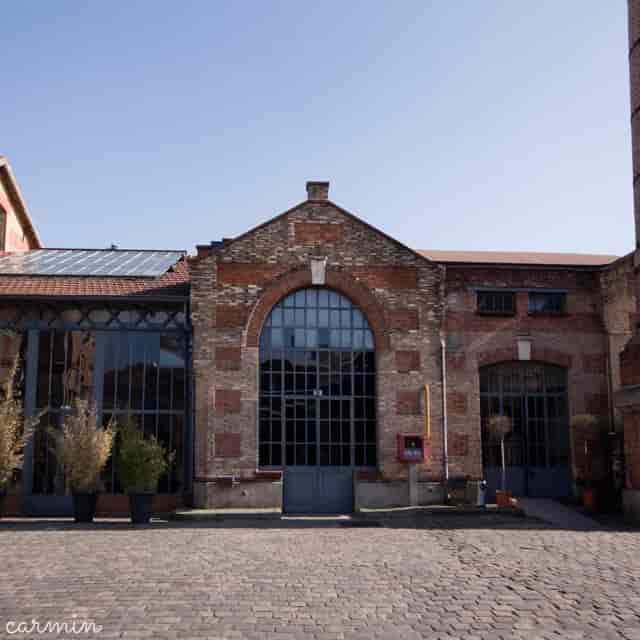Salle des alambics venue with brick and glass, perfect for corporate events and gatherings.