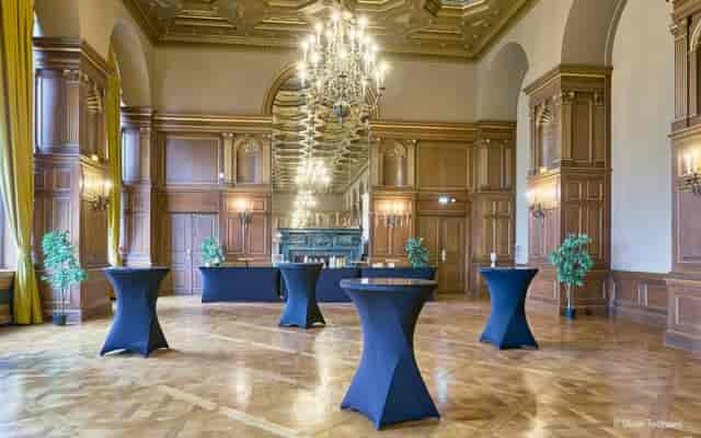 Elegant dining hall with wooden paneling, ideal for upscale receptions and networking events.