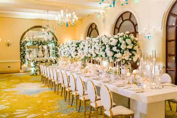 Elegant banquet setup with floral centerpieces at Condado Vanderbilt Hotel for upscale events.