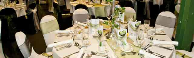 Elegant dining setup at Ffos Las Racecourse for corporate events, featuring refined décor and menus.