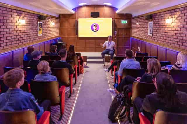 Grubstreet Cellars meeting space with screen, ideal for workshops and conferences.