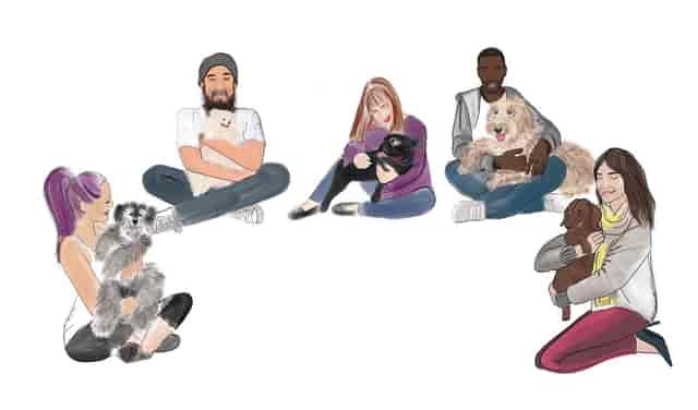 Diverse group in The Cuddle Club engaging with dogs at a networking event.