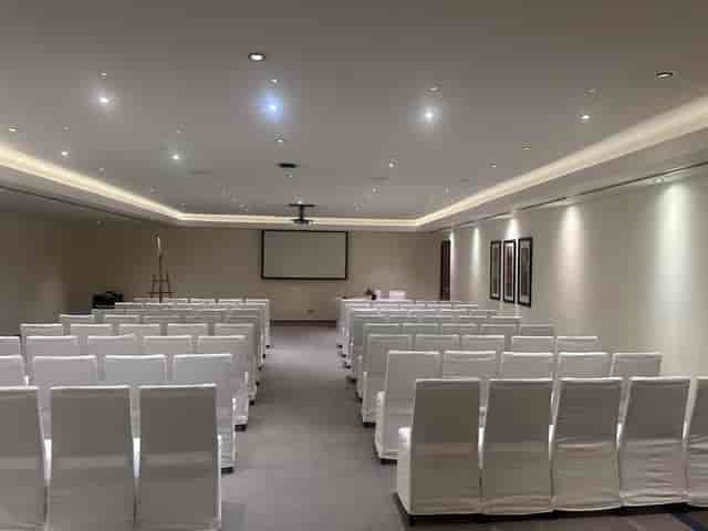 Abu Dhabi conference room with white chairs, ideal for professional meetings and presentations.