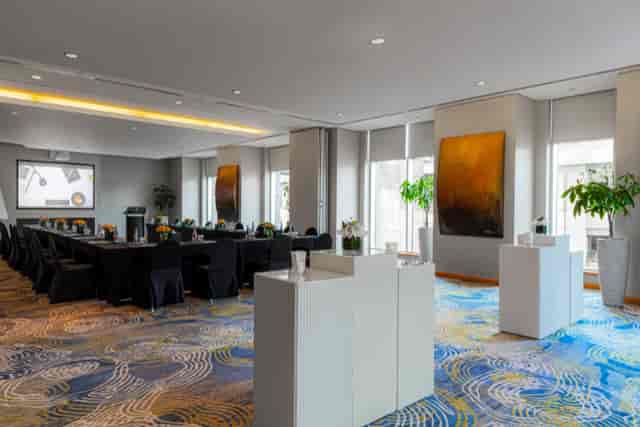 Modern meeting space in Address Dubai Mall with a long black table for corporate events.
