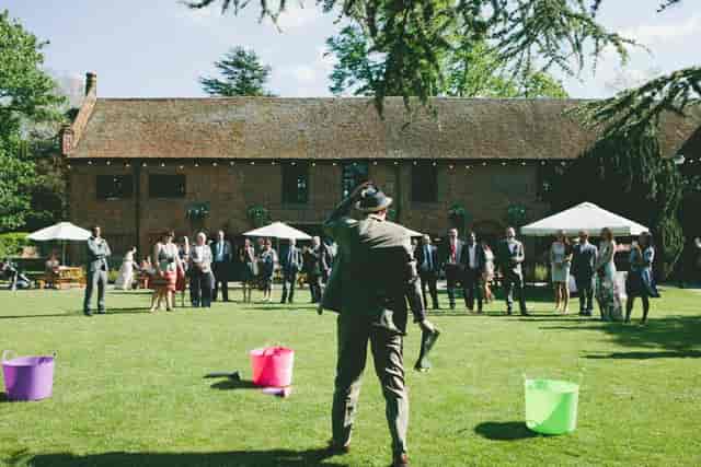 Vibrant outdoor wedding at Tudor Barn Eltham with elegant tents and guests mingling.