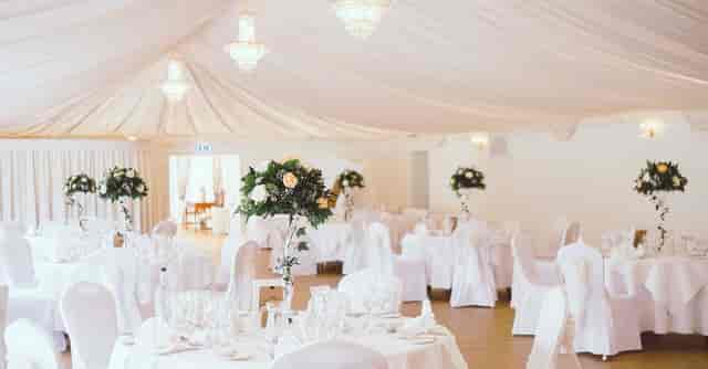 Chandelier-lit pavilion with elegant decor, perfect for weddings and upscale events.
